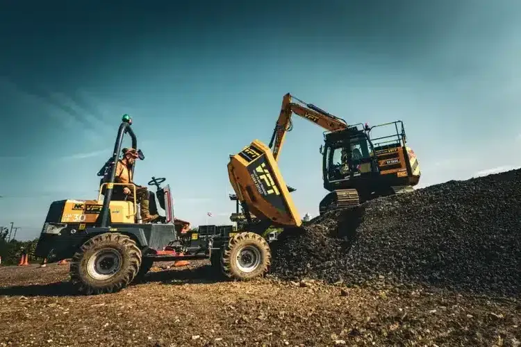 Dumper and excavator working at a plant training site